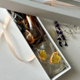 Small gift box with assorted fruit chips mix in carob chocolate and isomalt tea bombs