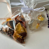 Small gift box with assorted fruit chips mix in carob chocolate and isomalt tea bombs