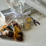 Small gift box with assorted fruit chips mix in carob chocolate and isomalt tea bombs